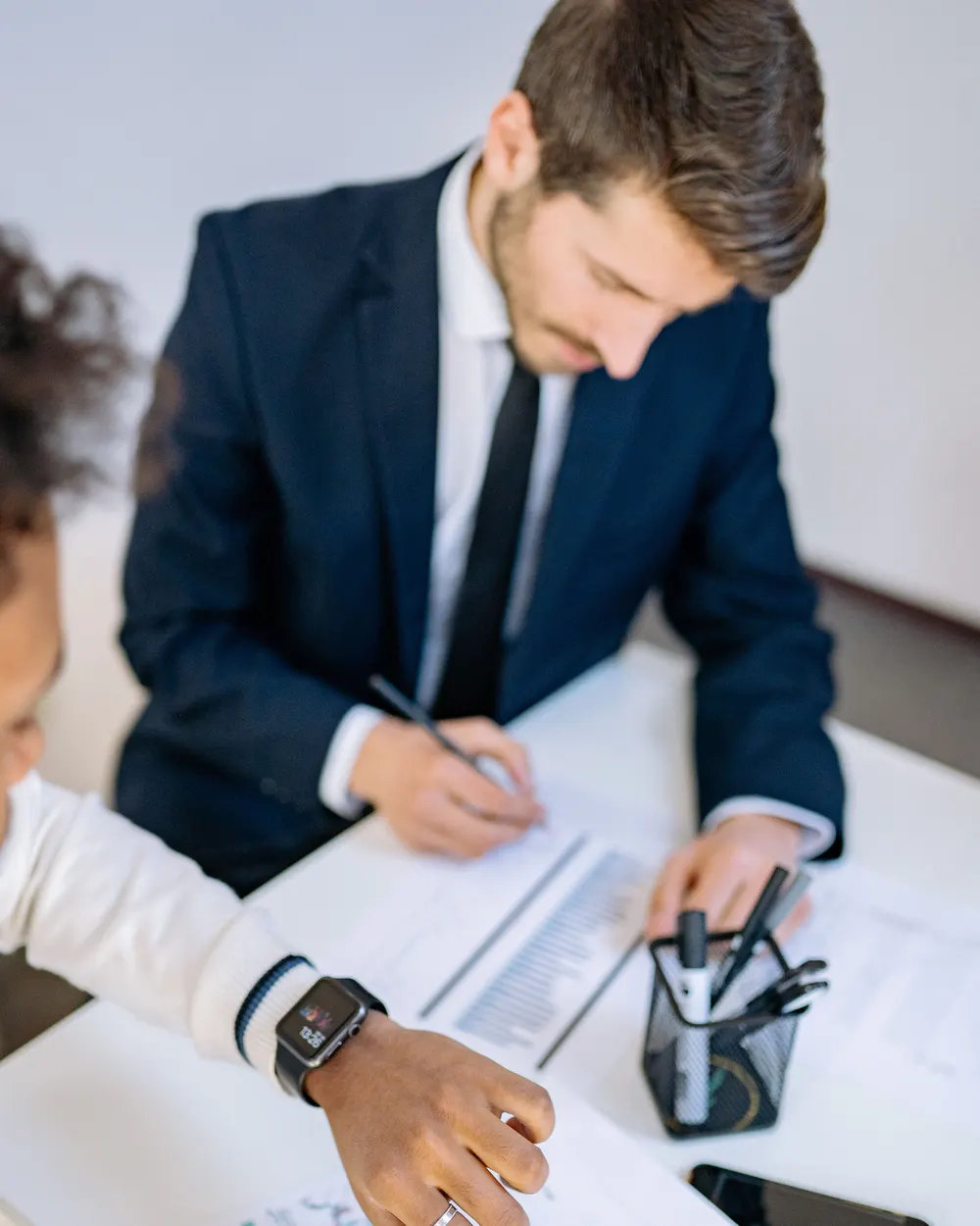 Two people reviewing financial documents at a table